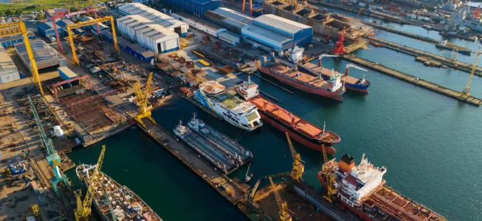 Drone view of a crowded industrial pier with multiple ship